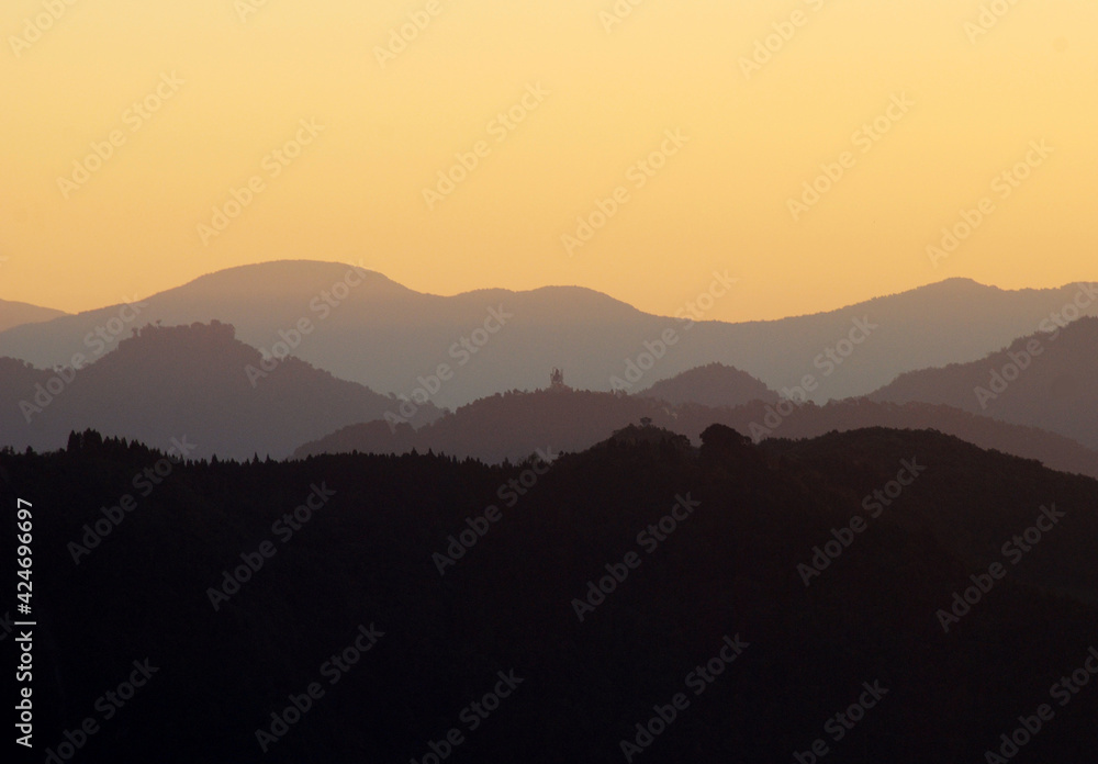 A panoramic view of horizon after horizon during sunrise as seen from Sombaria in Sikkim, India. This is one of the best sunrise view points in Sikkim where you can see layers of horizons.
