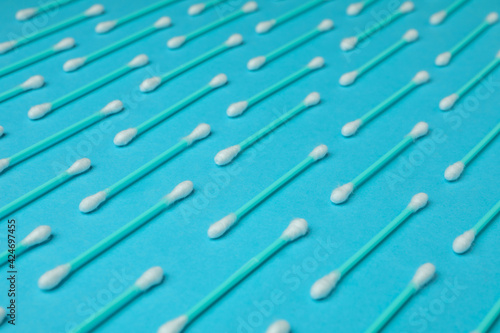Flat lay with cotton swabs on blue background