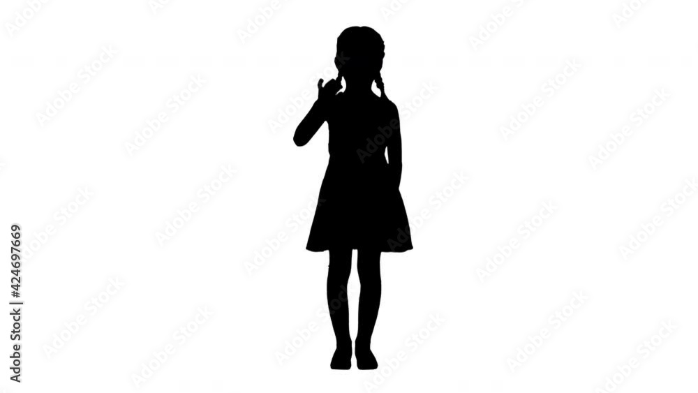 Silhouette Beautiful brunette little girl in polka dot dress waving to the camera. Silhouette Beautiful brunette little girl in polka dot dress waving to the camera.