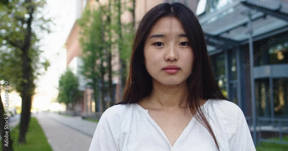 Smiling asian young woman in formal outfit looking to camera outside on street feel happy businesswoman portrait business beautiful modern manager pretty slow motion Smiling asian young woman in formal outfit looking to camera outside on street feel happy businesswoman portrait business beautiful modern manager pretty slow motion