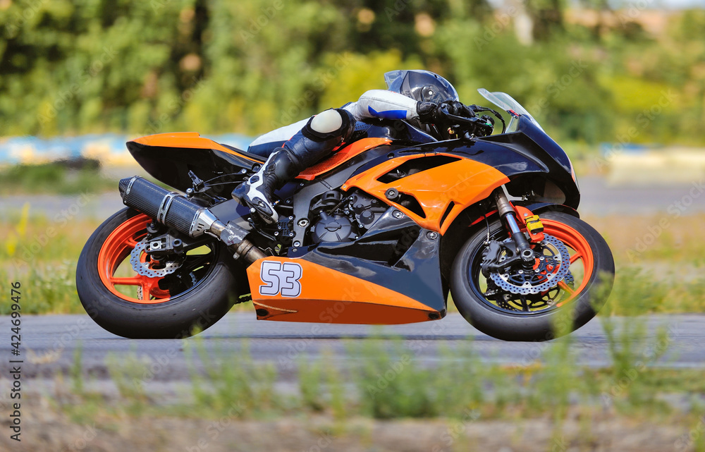 Motorcycle practice leaning into a fast corner on track Motorcycle practice leaning into a fast corner on track