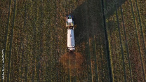 tractor with slurry tanker at work in the plowed field