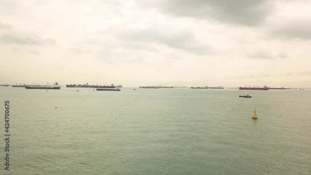 Sped up drone shot of boats moving in Singapore anchorage Sped up drone shot of boats moving in Singapore anchorage