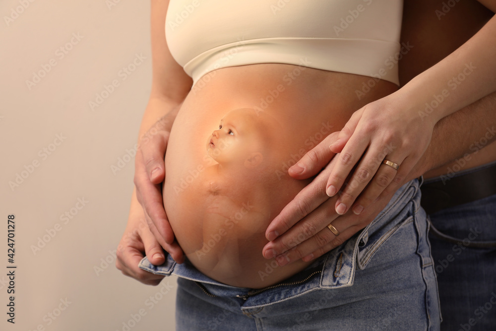 Man, pregnant woman and baby on beige background, closeup view of belly.  Double exposure Stock Photo