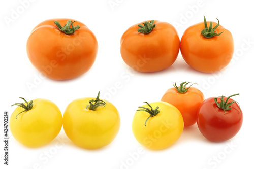 Mixed red and yellow,orange and red tomatoes on a white background