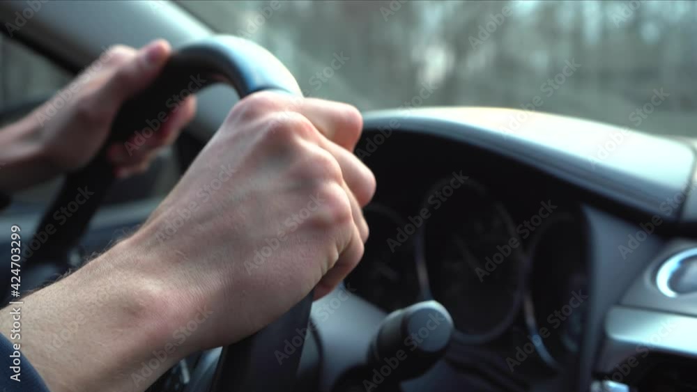 Close-Up Man Driver Hands on Car Steering Wheel. Man drives sport car in small european city at spring day. Shaky 4k footage Close-Up Man Driver Hands on Car Steering Wheel. Man drives sport car in small european city at spring day. Shaky 4k footage