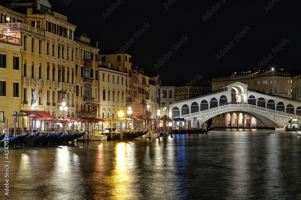 View of the famous Rialto bridge by night in Venice Italy 