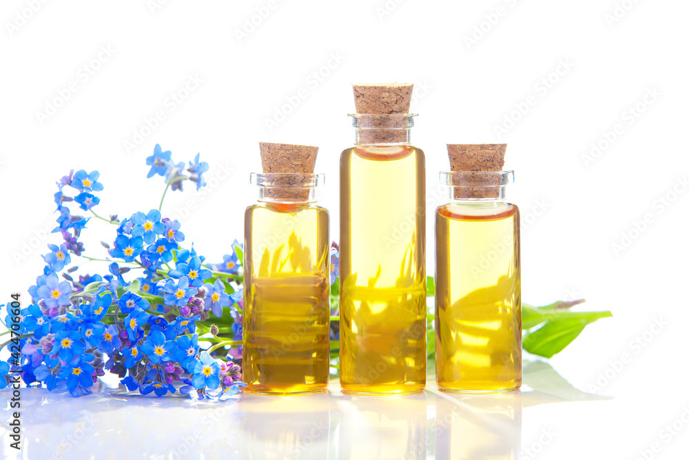 Essence of flowers on White background in beautiful glass jar Essence of flowers on White background in beautiful glass jar