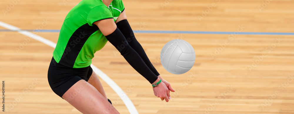 Volleyball player is a female athlete getting ready to serve the ball. Professional sport concept