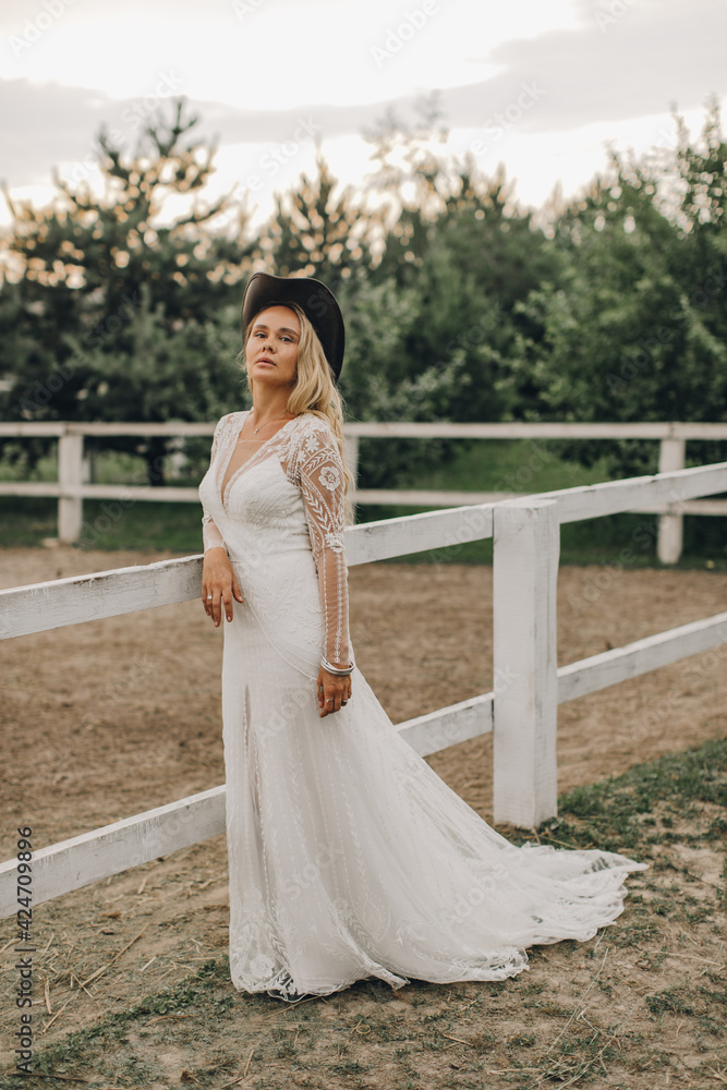 Portrait of the bride. A beautiful woman in white wedding dress in bohemian style. Sunset Portrait of the bride. A beautiful woman in white wedding dress in bohemian style. Sunset