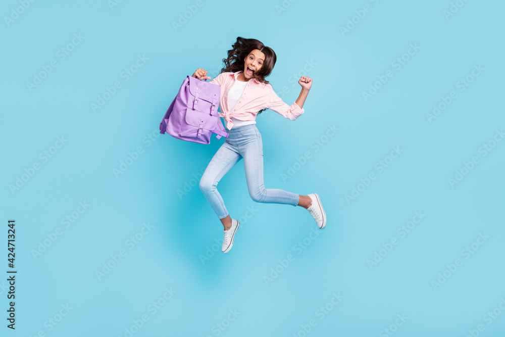 Full size photo of young happe excited crazy good mood schoolgirl jump passed exams isolated on blue color background