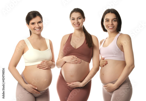 Happy young pregnant women on white background