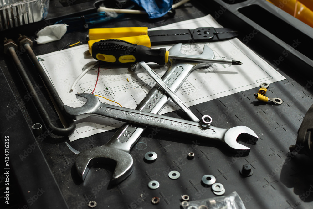 Fototapeta premium Messy set of tools on a working table in a garage
