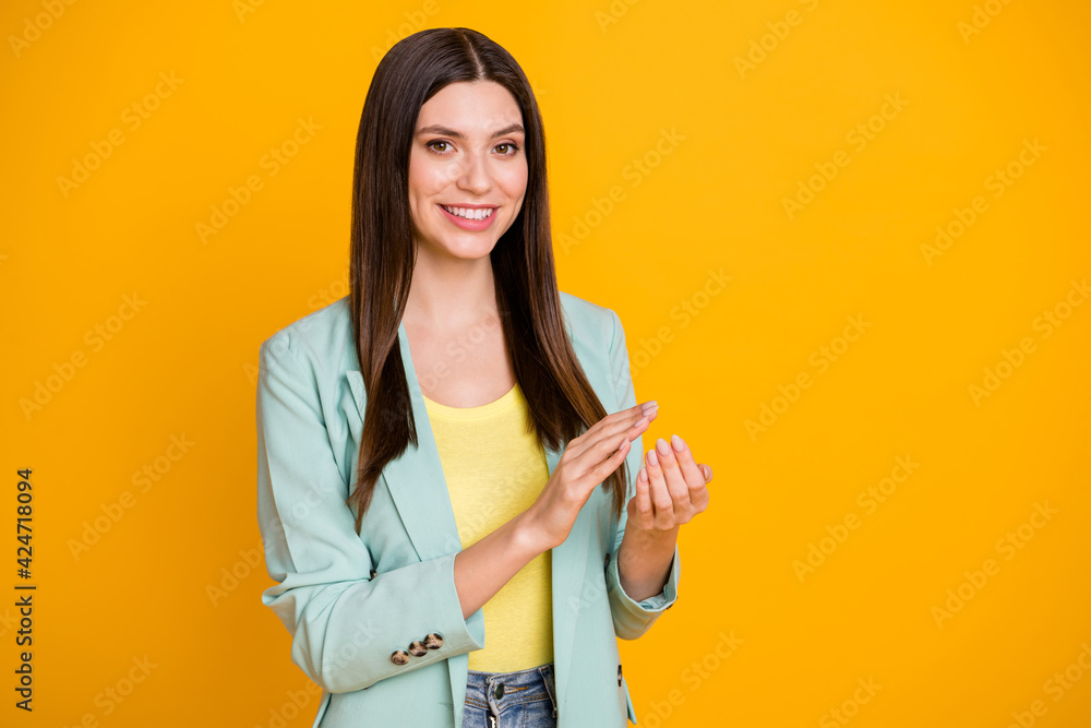Photo of adorable charming young lady dressed turquoise jacket applauding arms empty space isolated yellow color background Photo of adorable charming young lady dressed turquoise jacket applauding arms empty space isolated yellow color background