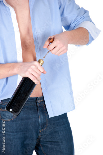 A man opens a bottle of his favorite wine