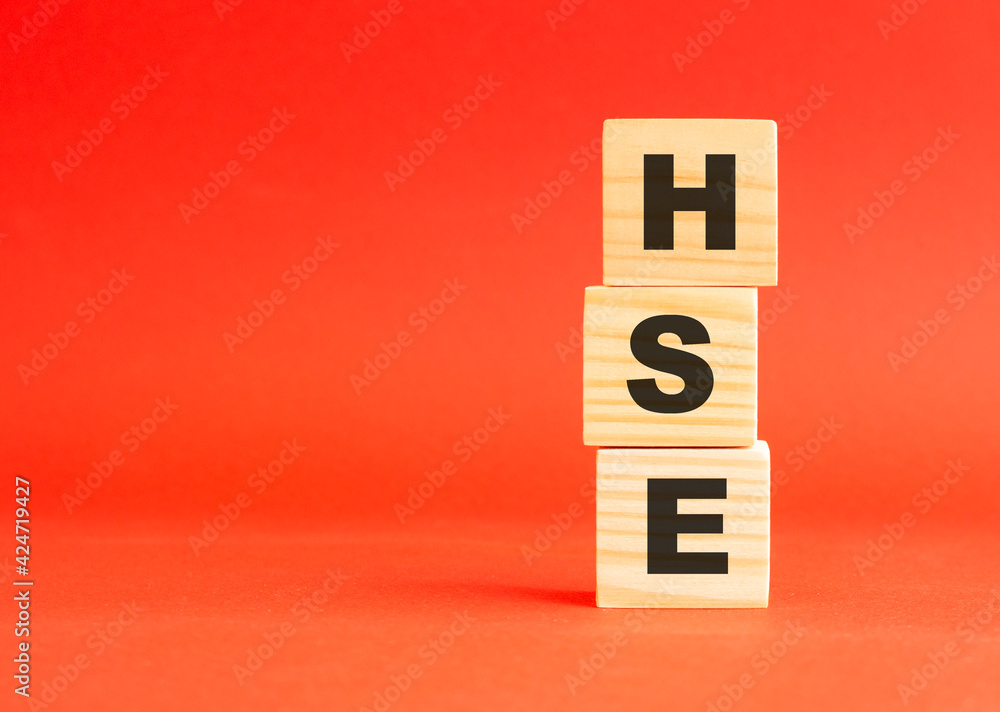 Wooden cubes with word HSE. Wooden cubes on a red background. Free space on the left. Wooden cubes with word HSE. Wooden cubes on a red background. Free space on the left.