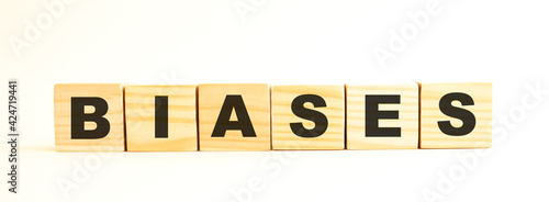 The word BIASES. Wooden cubes with letters isolated on white background.