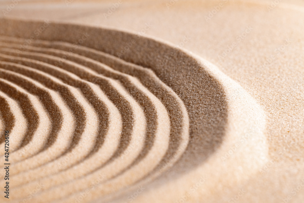 Naklejka premium Zen pattern in yellow sand, close up.
