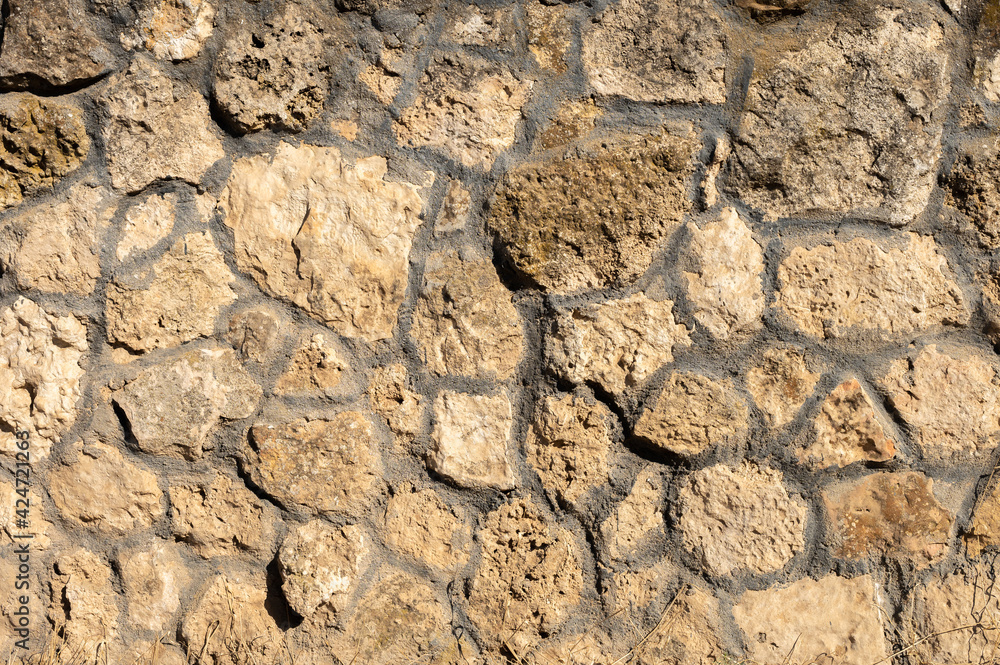 Fototapeta premium Decorative wall made of natural stone of various shapes and sizes. Interior background