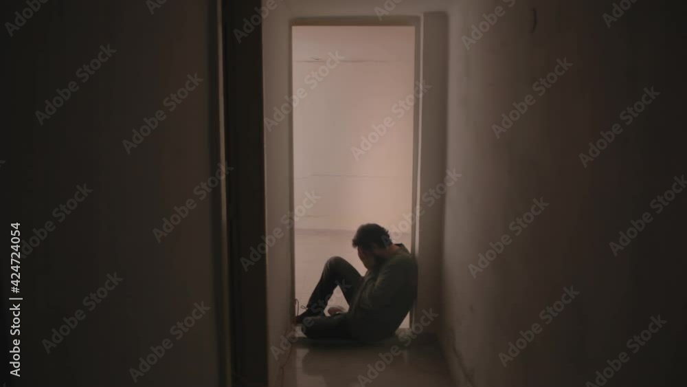 A sad desperate man, sitting on the floor near a door in his house, crying alone, letting his bad feelings come out.
A sad desperate man, sitting on the floor near a door in his house, crying alone, letting his bad feelings come out.