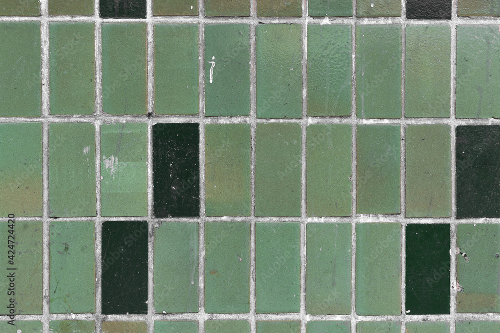 Old green tiles on the wall used for background