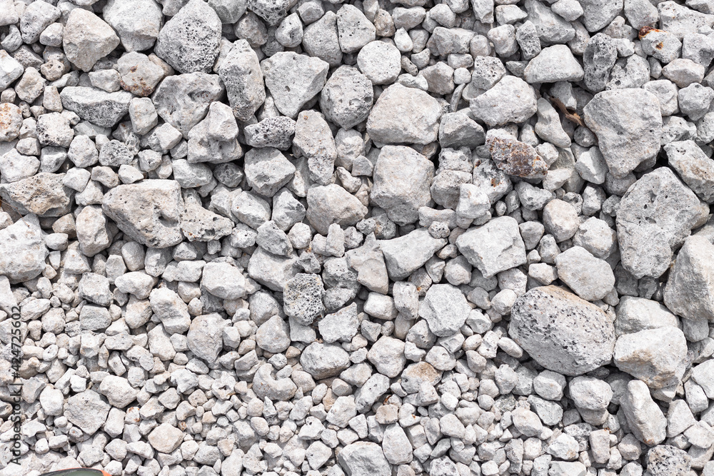 Grey ground stone rubble background of many small stones Grey ground stone rubble background of many small stones