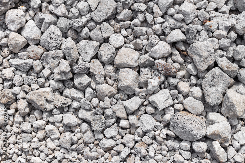 Grey ground stone rubble background of many small stones Grey ground stone rubble background of many small stones