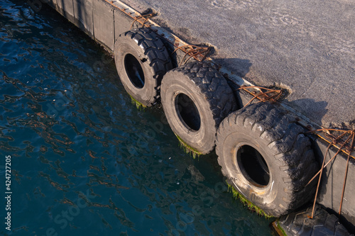 old truck tires at the pier, tire bumpers,