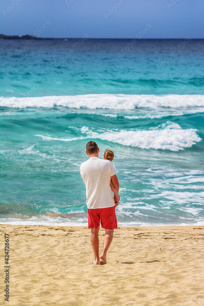 Father and son in Falassarna beach on Crete island, Greece, Europe. Father and son in Falassarna beach on Crete island, Greece, Europe.