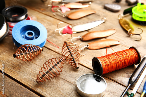 Different fishing equipment on wooden background