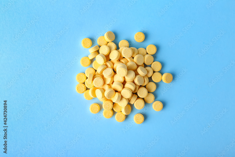 Folic acid pills on color background