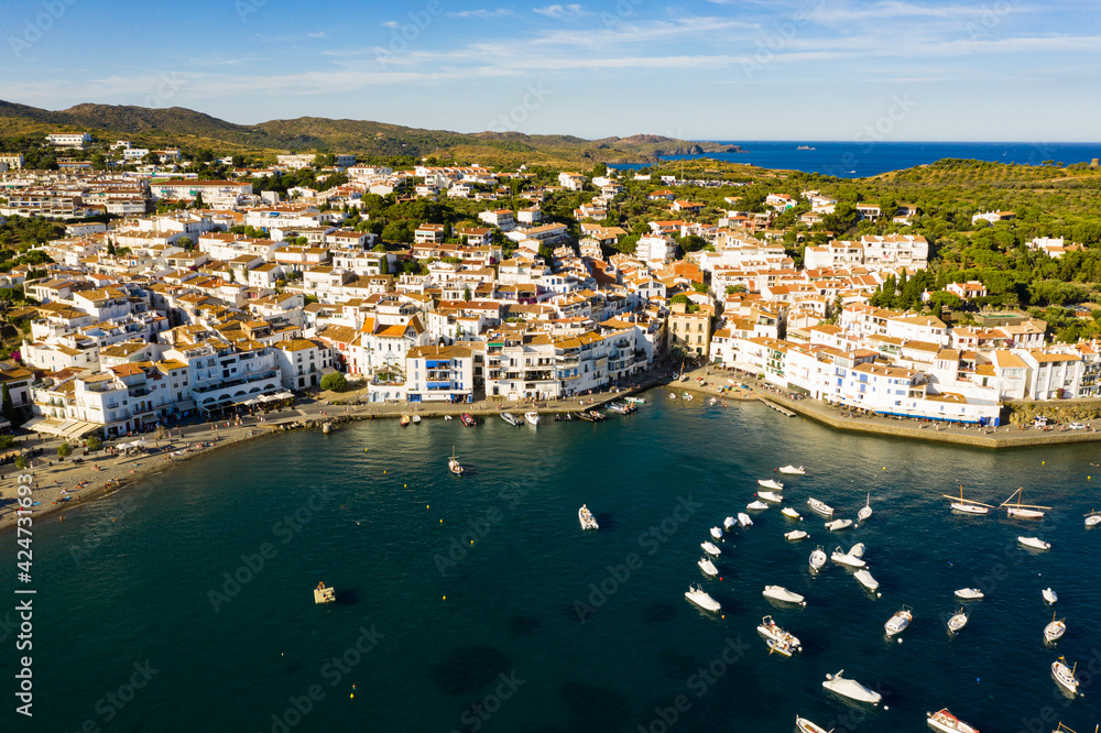View from drone of small town Cadaques and many boats in bay, Costa Brava, Spain, famous tourist destination