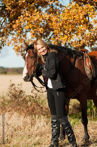 beautiful woman walking with horse