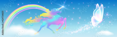Galloping iridescent unicorn with luxurious winding mane and flying butterfly against the background of the fantasy universe with sparkling stars, clouds and rainbow