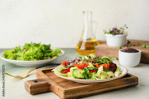 Plate of fresh salad with vegetables on table