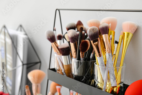 Set of makeup brushes on shelf