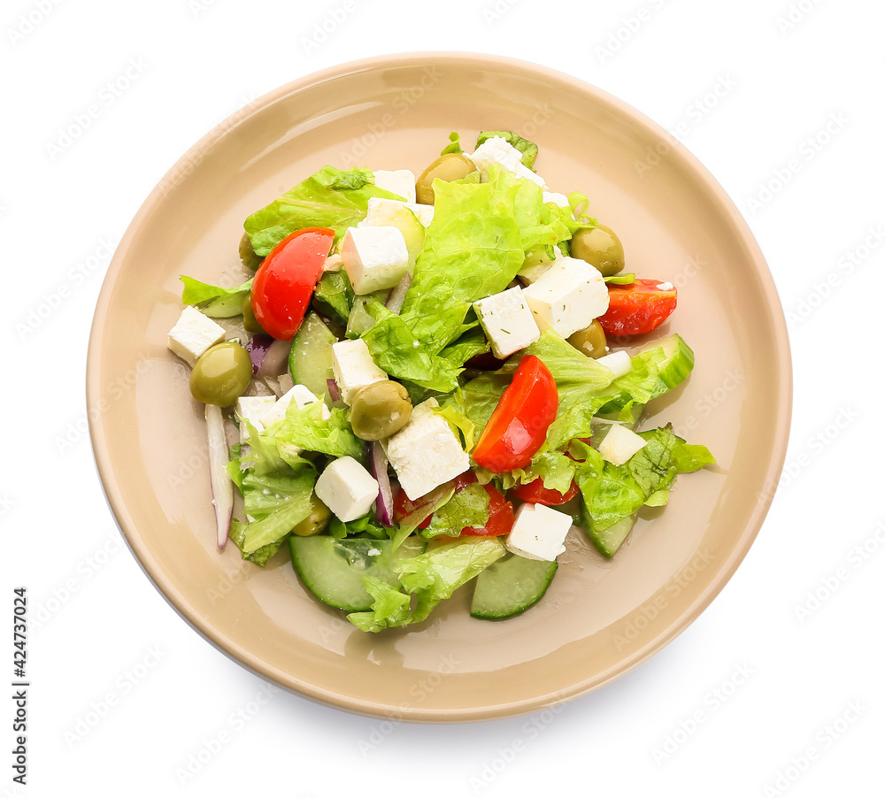 Plate with fresh Greek salad on white background