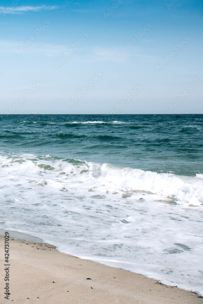 Deep blue stormy ocean water and blue sky background. Horizon of the sea
