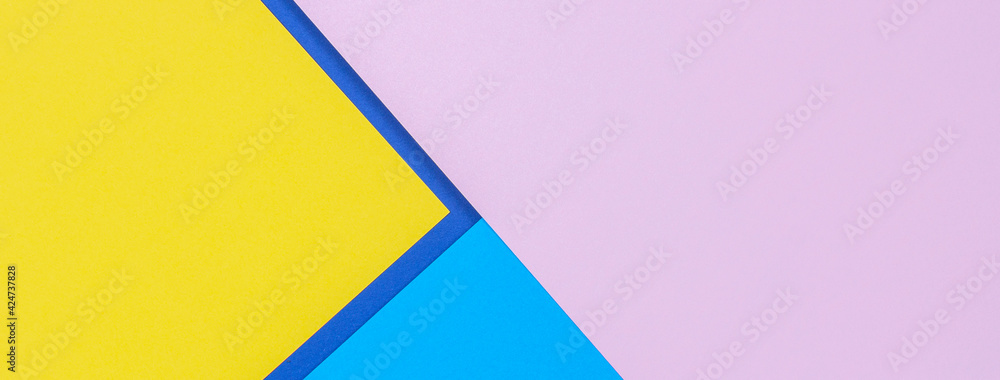 Creative abstract blue, pink and yellow color geometric paper compositon background, top view Creative abstract blue, pink and yellow color geometric paper compositon background, top view