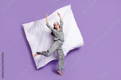 Full length body size photo of girl jumping wearing pajama dancing ballet near blanket isolated pastel violet color background