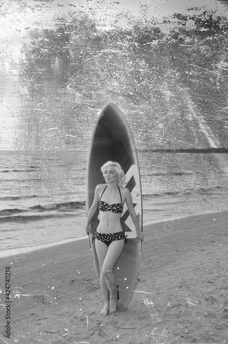 Photography Pretty blond girl model like Marilyn Monroe with surfing board on a beach