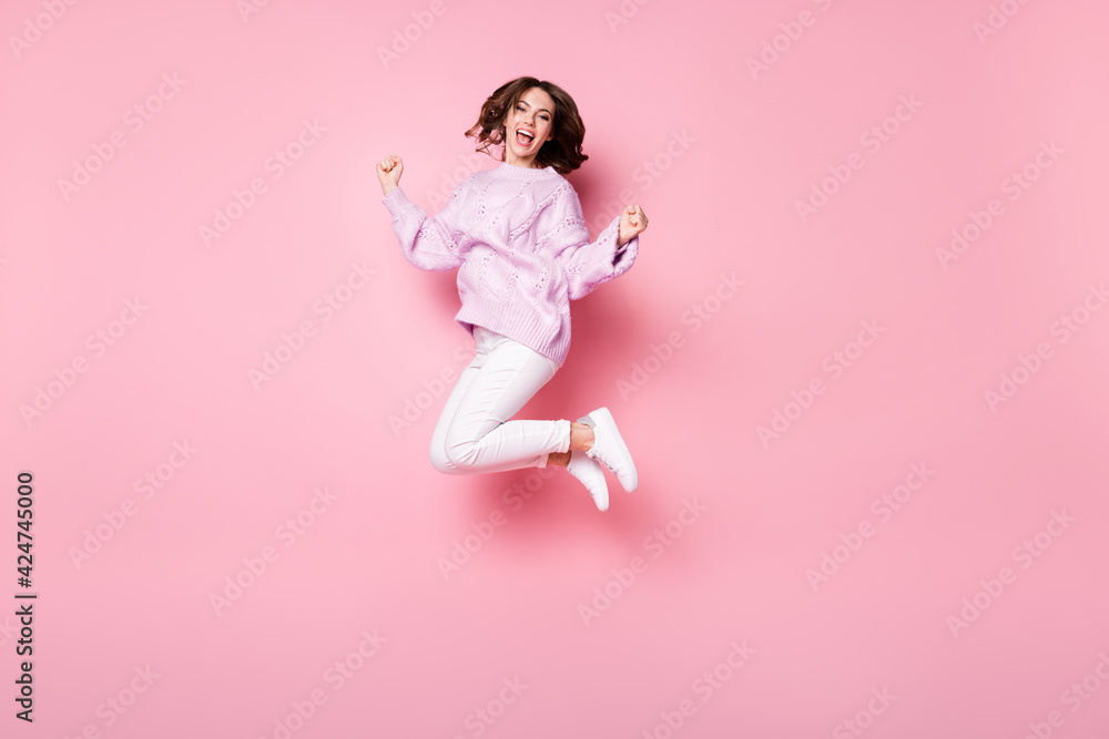 Full length body size view of lovely fit cheerful wavy-haired girl jumping celebrating having fun isolated on pink pastel color background Full length body size view of lovely fit cheerful wavy-haired girl jumping celebrating having fun isolated on pink pastel color background