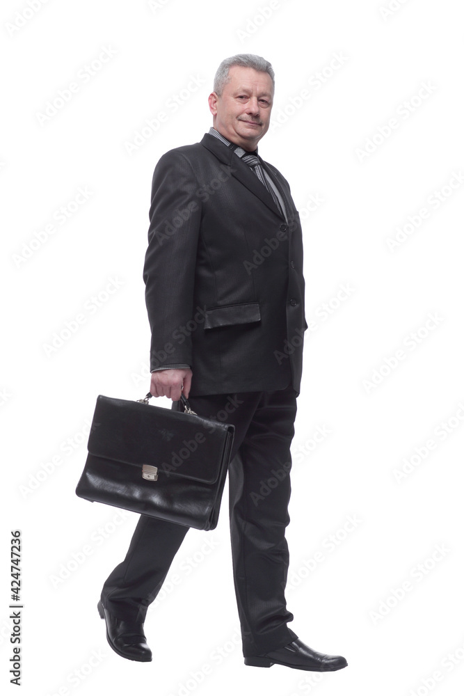 Confident businessman walking along with briefcase Confident businessman walking along with briefcase