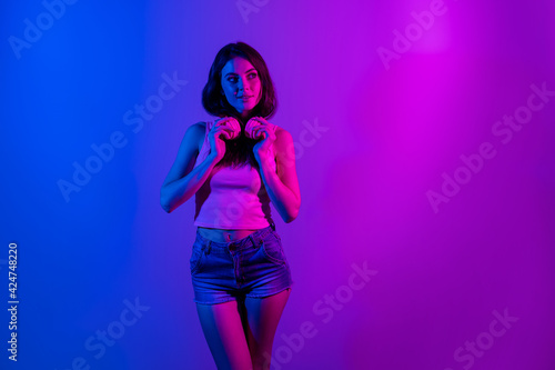 Photo of young beautiful attractive girl with headphones look copyspace dreaming isolated on neon blue color background © deagreez