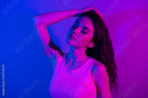 Photo of young stunning gorgeous elegant woman dreaming with closed eyes isolated on glowing blue color background