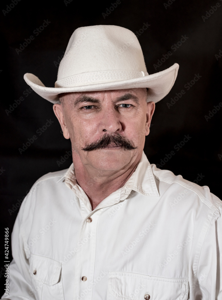 The cowboy with mustache in a white hat The cowboy with mustache in a white hat