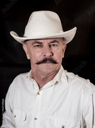 The cowboy with mustache in a white hat