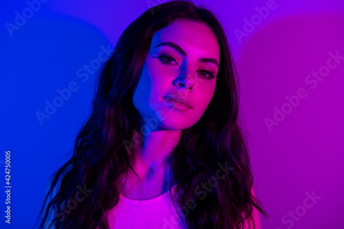 Photo of young attractive girl ultraviolet lights party club enjoy isolated over vibrant color background
