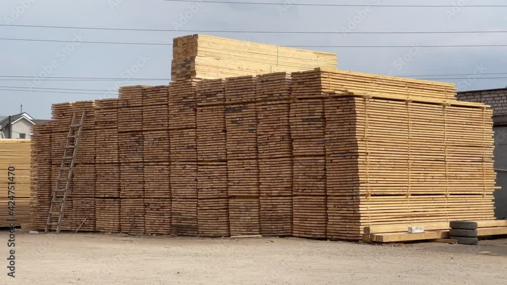 Wooden boards, lumber, industrial wood, timber. Pine wood timber stack of natural rough wooden boards on building site. Industrial timber building materials Wooden boards, lumber, industrial wood, timber. Pine wood timber stack of natural rough wooden boards on building site. Industrial timber building materials