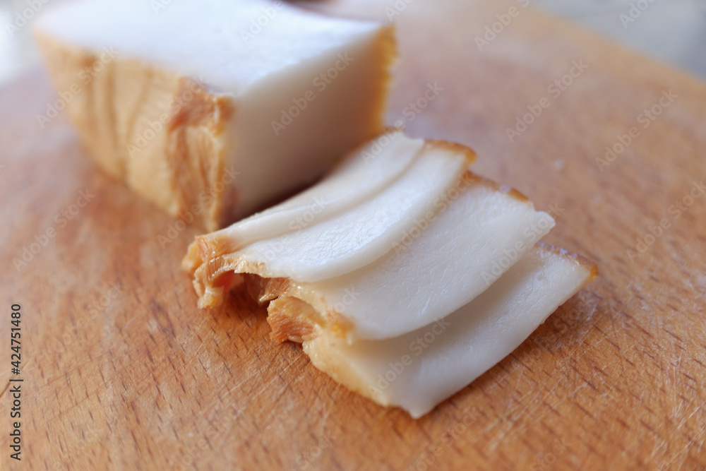 delicious sliced lard on a wooden plate . Food background close-up delicious sliced lard on a wooden plate . Food background close-up